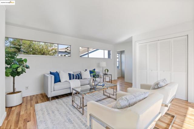 Living area with light wood finished floors and baseboards