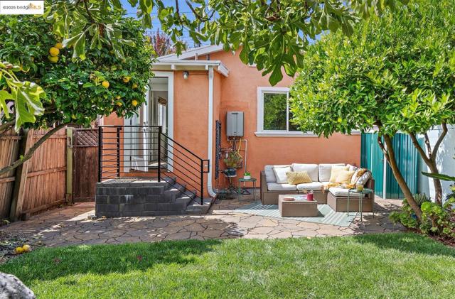 Back of house featuring a fenced backyard, a patio, stucco siding, and outdoor lounge area