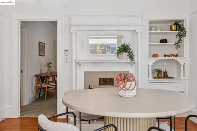 Dining room with wood finished floors and a tiled fireplace