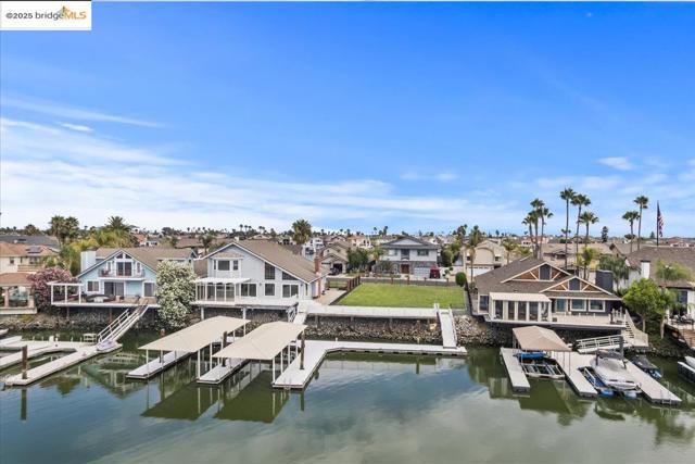 Dock with boat lift, a residential view, and a water view