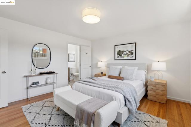 Bedroom with light wood-style flooring and ensuite bathroom