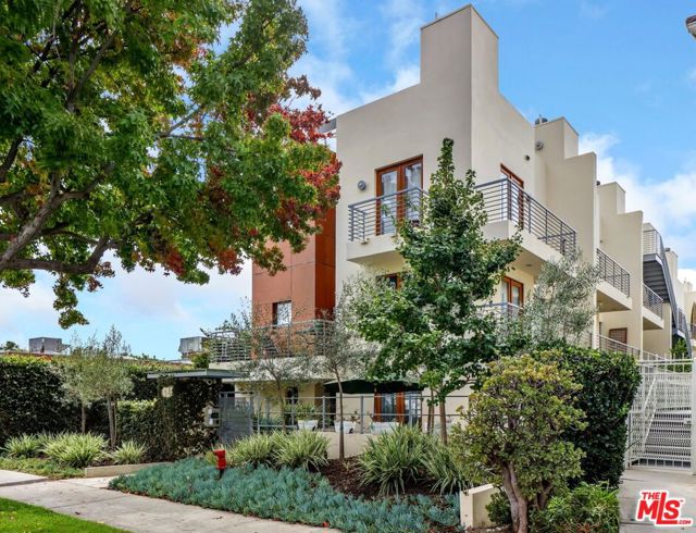 1544 11Th Street 5 Santa Monica, California Turnkey tri-level modern architectural designed by world-renowned architect Howard Laks (The Proper Hotel, Brentwood Country Club). Nestled behind privacy hedges, and controlled access gates, this 2 bed/2.5 bath + loft steel-frame townhome is the ideal combination of form and function. Multiple spaces to work from home, relax by a fireplace with a book, or entertain guests; including a large private roof deck w/360 views of the city lights, Santa Monica mountains, and a peek of the ocean. Open-concept living spaces featuring an L-shaped kitchen w/stainless steel Miele appliances and oversized built-in GE Monogram refrigerator. Splashes of color tiles and wallpaper elevate the maximal aesthetic while polished concrete floors throughout preserve the sleek minimalist core. Convenient alley access to a 2-car, side-by-side parking w/EV charging + huge private storage unit. Only 11 blocks from the beach, a quick stroll/ride to all downtown shopping, farmers markets, and more.