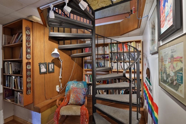 Reading/library nook at the base of the spiral staircase