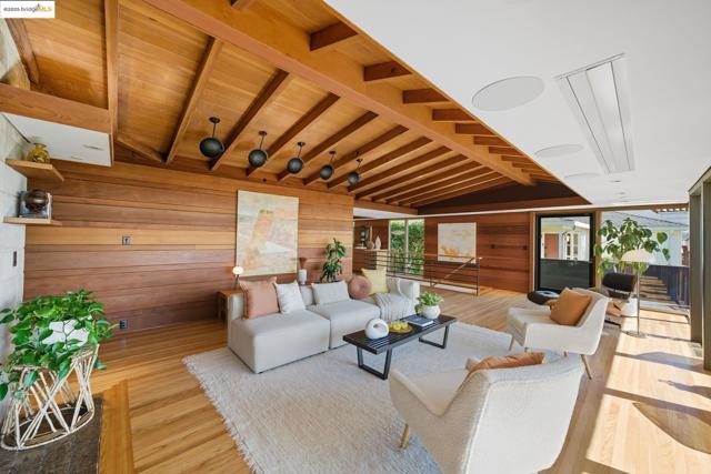 Living area featuring wood walls, light wood-style floors, and wood ceiling