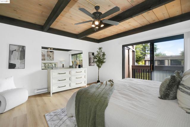 Bedroom featuring a wood ceiling with exposed beams, light wood-style flooring, ceiling fan, access to outside, and baseboard heating