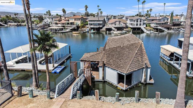Dock featuring a residential view and a water view