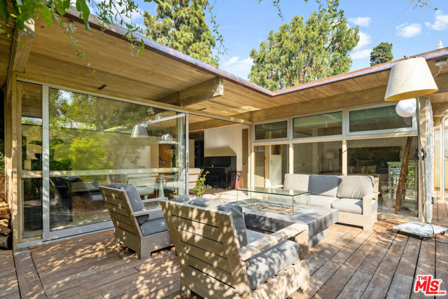 229 Amalfi Drive Santa Monica, California William Wallace Reid, Architect,1953. This unassuming, private, sublime, sanctuary, is a South facing, jewel box. Placed on the brow of the canyon its floor-to-ceiling windows, and upper skylights, are strategically placed, capturing light and framing the borrowed space and views while coddled by mature trees and ocean breezes. The house is a work of art and a testament to details & style embracing the original post & beam design and vision of Architect William Wallace Reid and his wife Paula. The current owners stayed true to the original, complementing its soul with the comforts of the 21st century. Every part of the house has purpose without compromise of design. When entering the house one is immediately struck by the elevated materials and setting in nature. The house includes a luxurious main bedroom suite. When open to the living room the house is perfect for one or two individuals while also brilliant for entertaining the extended family and friends. The living room opens to the patio/gardens and canyon views with floor-to-ceiling windows and open beamed ceiling. The spacious family room and second bedroom/bath offer elevated comfort plus plenty of storage. The open cook's kitchen opens to another private outdoor kitchen/patio area enhanced by the pizza oven with the backdrop of a mature Eucalyptus tree. The house is situated on a street-to-street lot with the potential for adding a well thought out garage and ADU while still preserving the privacy of the existing house. The house is being sold fully furnished and outfitted. You can see plans for the ADU under the "Documents" tab.
