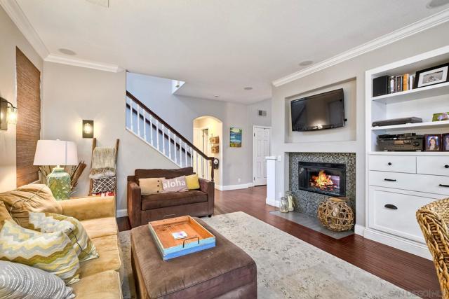 Dual-sided, gas fireplace is so cozy! The beautiful wood built-ins keep everything tidy.