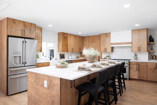 Custom hand built cabinets and porcelain backsplash along with upgraded appliances are the highlights of this kitchen