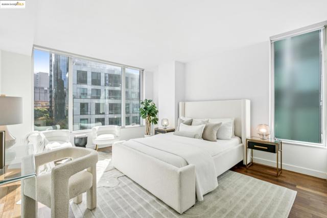 Bedroom with wood finished floors and baseboards