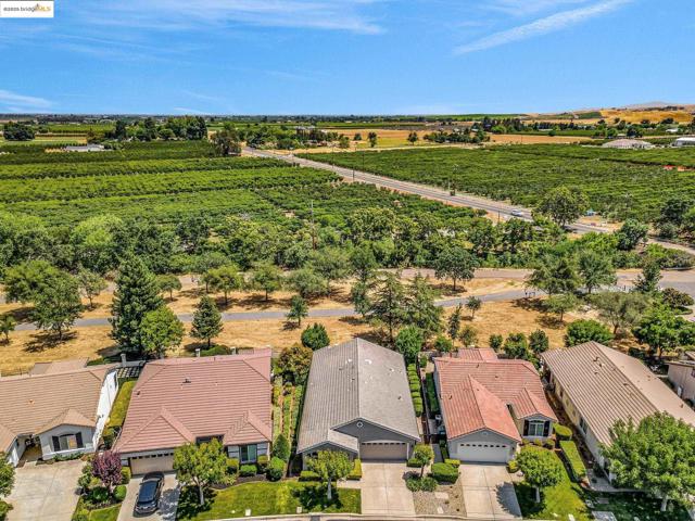 Overview of rural landscape with large plots for crops and nearby suburban area