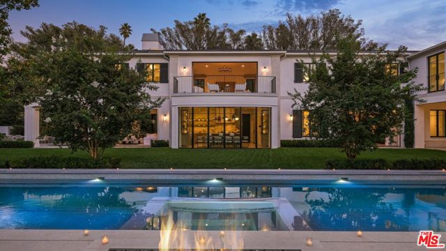 Indisputably elegant and inviting, 1000 Laurel Way is where inspired modern design meets the best of refined Beverly Hills living. Known as The Laurel House, this nine-bedroom, 14-bathroom estate has been masterfully crafted by famed West Coast-based architect William Hefner and encompasses nearly 16,000 square feet of bright, airy living areas over three levels. Set on nearly one acre, The Laurel House is a shining example of Hefner's signature style, which seamlessly blends timeless interiors with the outdoors to create breezy, host-ready spaces that are at once airy and intimate. Inside, a double-height entry presents a grand statement staircase and endless alluring design details, including hardwood floors, eye-catching light fixtures, stately columns and artfully arched windows. The open main-level floor plan features a chef's kitchen with marble-topped counters, a large eat-in island, stainless steel appliances plus a breakfast area and adjoining family room all imbued with natural light from walls of windows. Two offices with ensuites offer seamless, professional work-from-home spaces. A second catering kitchen is located behind the main kitchen, ideal for accommodating large-scale events. A gallery hall connects the kitchen to the formal dining room and living room, which is lined with glass pocket doors that disappear to reveal the expansive, park-like grounds' mature trees and privacy-enhancing foliage, a sparkling reset oversized pool with built-in seating, an outdoor kitchen, stand alone resort-style cabana, fire pits and a lush expanse of grass.  Ascend to the second level to find four ensuite bedrooms with adjoining family rooms, as well as the primary suite with dual baths both with soaking tubs a private bar, fireplace, designer closets and two balconies overlooking the verdant grounds. The lower level is an entertainer's dream, replete with two ensuite bedrooms, a glam room, a 12-seat screening room, wine cellar with a tasting room and gym with an infrared sauna. Additional home amenities include a one-bedroom detached guest house and a gallery garage that can accommodate up to 10 cars. The Laurel House is where today's most discerning residents can revel in classically chic, resort-like Beverly Hills living from within a true architectural masterpiece. This one-of-a-kind home is conveniently located just 5 minutes from The Golden Triangle's shops and restaurants and the iconic attractions of West Hollywood and The Sunset Strip. Property is also available For Lease at $165,000/Mo.