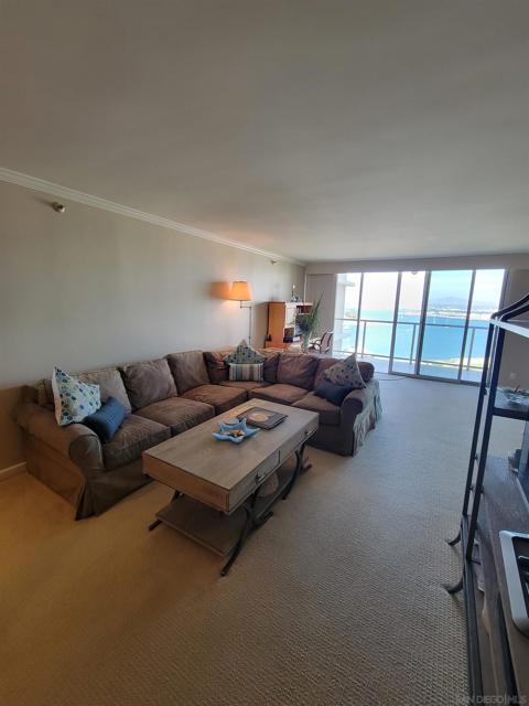 Living room looking towards the spacious balcony. Sof is a sofa bed.