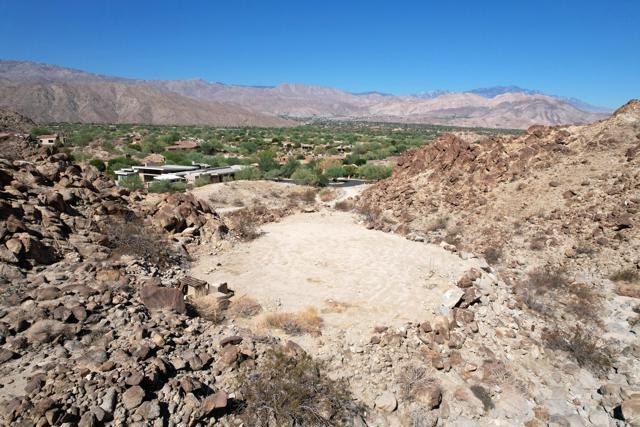 New to the market, this exquisite custom homesite offers the rare opportunity to design the desert home of your dreams on 2.33 acres net / 3.71 acres gross. This is the largest site within the exclusive Reserve Club, and is situated in a majestic cove nestled in nature and the beauty of surrounding outcroppings. The tranquil setting awaits the creation of elevated pads to accommodate the main house, guest suites, a studio or gym. Each site will capture dramatic desert light and shadows, with stunning views to snowcapped mountains and soothing sunsets. If you seek privacy and envision a true 'desert retreat' within one of the most captivating and natural settings available in the Coachella Valley, come see the potential for perfection!
