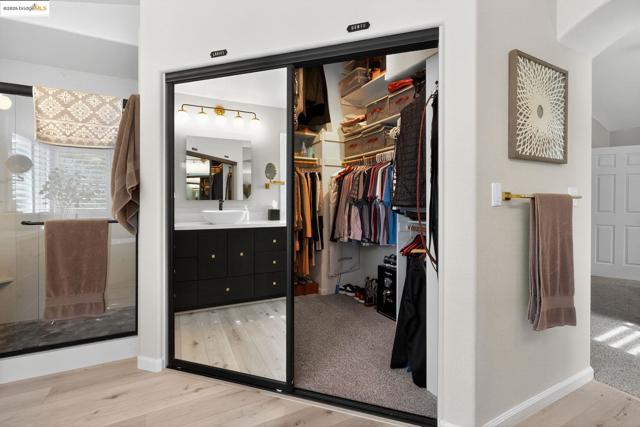 Walk in closet featuring light wood-style flooring and a sink
