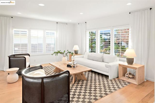 Living area featuring light wood-style floors, recessed lighting, and plenty of natural light