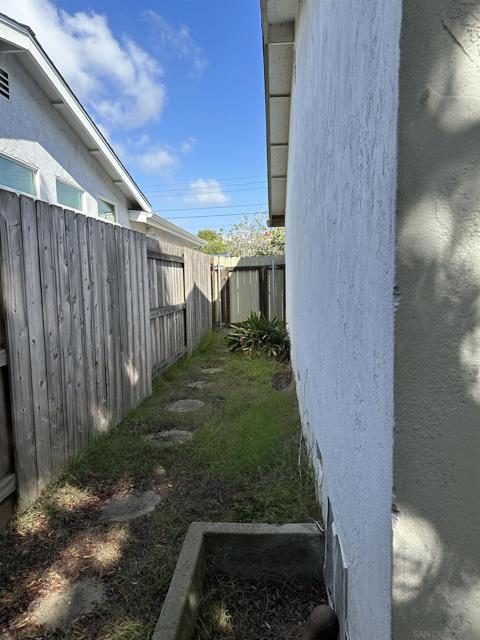 Side yard with access to underneath the home (raised foundation).