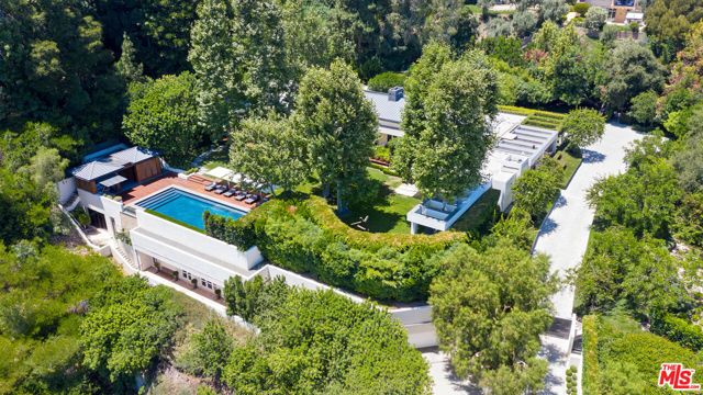 One of Beverly Hills most private and secluded estates, situated on over 3 acres.  A sprawling contemporary compound featuring a 9,200 sf (4 bd/6bth) 1 story main house, 2 guest houses, separate gym, gorgeous pool with pool house and underground garage. Impeccably remodeled with the highest level of quality, taste, and craftsmanship. Featuring resort-like grounds, stunning outdoor living, dining and entertainment areas, a reflecting Koi pond, manicured lawns, and zen-like gardens. Beautiful city and ocean views throughout complete this incredible and irreplaceable estate. Shown to pre-qualified clients only.