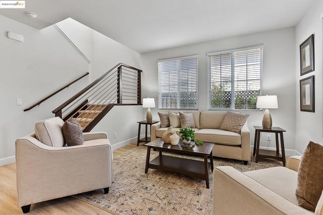 Living room with light wood-style floors and stairs