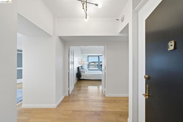Entryway featuring light wood-finish flooring, white walls, and a modern ceiling fixture