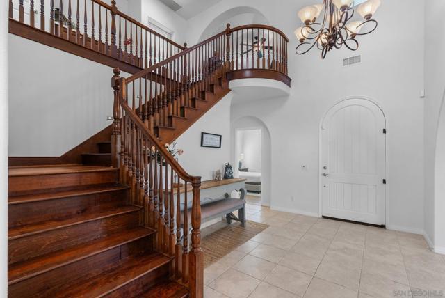 Entryway looking back towards front door from stairs with guest bedroom 1 (of 2 on first level)