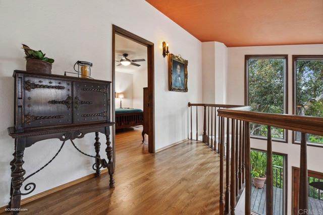 The staircase leading to the second story mezzanine is open to the living room below