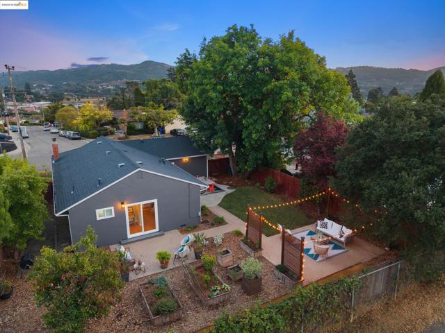 Aerial view of property and surrounding area featuring a mountainous background
