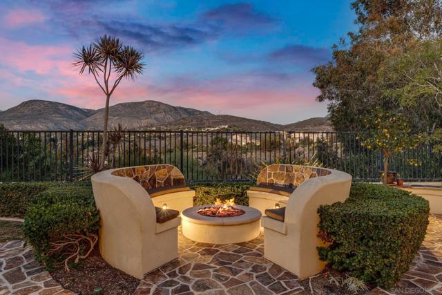 Scenic backyard retreat with a built-in fire pit, stunning golf course and canyon views. The perfect spot to unwind and enjoy breathtaking sunsets.