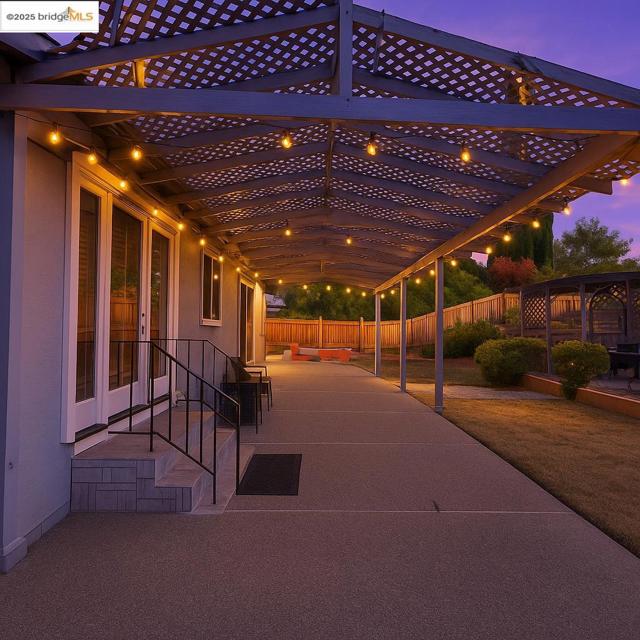 Patio terrace at dusk with a fenced backyard and a patio