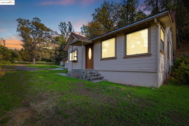 View of front of home with a front yard and entry steps