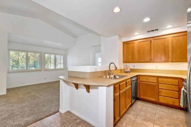 The bright kitchen opens up to the living room / dining room combination.