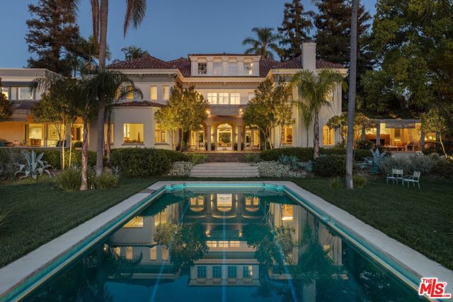 :: The renowned R.W. Pridham Residence, also known as "Villa Marnel" :: One of the most sought after and storied estates in Hancock Park :: Magically woven into the historical fabric of Los Angeles, The Pridham Residence tells an unrivaled story of legacy and celebrity :: Originally built by business and civic leader R.W. Pridham, who proudly sat as Chairman of the LA County's Board of Supervisors, the 8390 Square Foot home is a harmonious marrying of Spanish Mediterranean, Federal and Italian Renaissance styles. Remarkably intact, a keystone arched entry door, Corinthian columns, oversized fanlight windows and hipped dormers are just some of the original exterior hallmarks of the residence. Inside, emotional Federal Revival details welcome one into the cathedral entry and living space which includes a grand sweeping staircase, detailed balustrade and dentil moldings that coat almost every wall and ceiling, all astonishingly unblemished. A walnut paneled office with parquet floors overlook the large pool and grounds. Situated on almost an acre of land, the Pridham residence boasts unblocked views of the Wilshire Country Club from every rear window, pool, multiple decks and the two custom cabana's that flank each side of the park-like yard, surrounded by thoughtfully designed landscaping. One of only 7 incredibly rare double lot properties in Hancock Park, the estate was also owned by Olympic athlete Ray Dodge, and is most known for it's ownership under the legendary Frank Sennes, who founded the highly successful Moulin Rouge, which was the biggest nightclub and showroom in America at the time. The home was also rumored to have been a crash-pad for Frank Sinatra, and has hosted several celebrity, political events, weddings and was featured in films. A unique opportunity for a rare transfer of legacy.