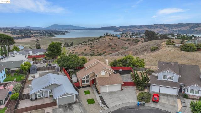 Aerial perspective of suburban area featuring a water and mountain view