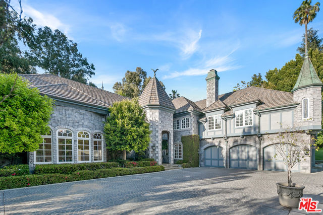 A rare opportunity to purchase this 8182 square foot custom built Chateau on more than a half-acre of land in Holmby Hills. The grandeur of the estate is immediately apparent upon entering the property through the large gated motor court. The home is designed for the ultimate entertainer, with large dramatic spaces, 30 foot high ceilings and an abundance of natural light throughout. The formal foyer flows effortlessly into the grand living room, great room and formal dining room, with fireplaces in all of them. The living room and great room both open directly to the outdoor entertainment areas. The spacious primary suite features a fireplace, a large terrace overlooking the backyard, luxurious dual bathrooms with sauna and spa tub and room sized walk-in closets. The home also has 3 additional bedrooms and a lower-level maid's room, chef's kitchen with walk-in pantry, breakfast room, a large temperature controlled underground wine cellar attached to a separate tasting room, an elevator and a 3 car garage. The tranquil backyard is great for entertaining with expansive patio spaces, a pool, spa and beautiful landscaping. 10101 W Sunset is a unique opportunity, surrounded by some of world's most expensive estates and situated moments away from world-class shopping, dining and entertainment including the Beverly Hills Hotel, Rodeo Drive and the LA Country Club, all moments away.
