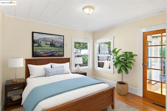 Bedroom featuring wood finished floors and ornamental molding