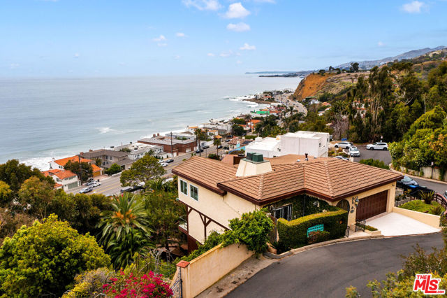 This lovely romantic villa overlooking the Malibu and southern coastline is located in the desirable La Costa neighborhood.  Perched above the coast but only a minute or two from Pacific Coast Highway, this home is conveniently located close to all things Malibu while providing the feeling of being on holiday on the Italian Coast.  The spectacular 180 degree ocean views greet you immediately upon entering through the front door. See the waves crash onto shore and the city lights at night from the sunny living room with fireplace, dining room and kitchen with breakfast area. A large balcony allows for outdoor dining and lounging while taking in the views as well. A distinguished office with fireplace and romantic in-ground private spa finishes off the entry floor. Downstairs are all the bedrooms - including the primary with cedar-wood walk-in closet and dual bathrooms. An additional large den, with separate entrance, and exercise room are also on the lower level. Practice your putting game on the two putting areas attached to the home. This home has the coveted La Costa Beach and Tennis Club rights.