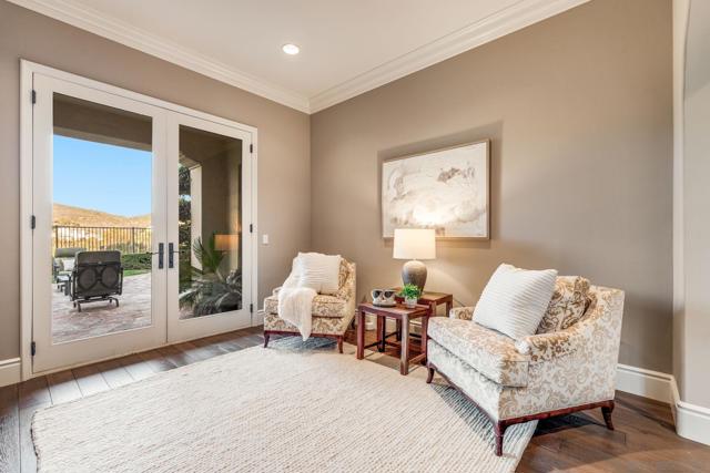 Elegant Seating Area off the dining room, featuring French doors that open to the backyard for seamless indoor-outdoor living.