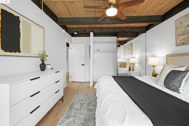 Bedroom with a wood ceiling with exposed beams, light wood-style flooring, and ceiling fan
