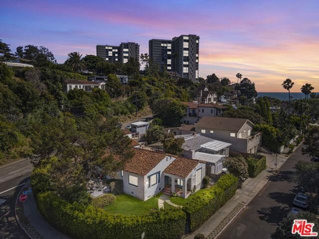 266 Mabery Road Santa Monica, California Situated on one of the most coveted streets in Santa Monica Canyon within close proximity to the beach, Palisades Park, Montana Ave, and the Palisades Village this timeless villa offers high ceilings with exposed beams, arched doorways, hardwood floors, large picture windows with views of Santa Monica Mountains, retro bathrooms, and even an underground cellar. The expansive corner flat lot offers a grassy area, paved sitting area for entertaining and a detached 2 story garage with endless possibilities. A long driveway offers ample parking. Whether you're headed to the beach or do the Santa Monica Stairs this location offers the best and sweetest air quality around. This address utilizes LA services and schools with access to the highly rated Canyon Charter Elementary school. Plans have been submitted for a new build and are available upon request.