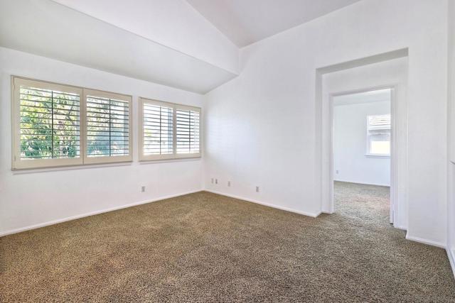 Vaulted ceilings and custom shutters make give the living room a very open feel.