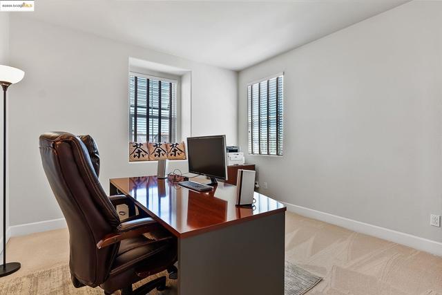 Carpeted home office with baseboards