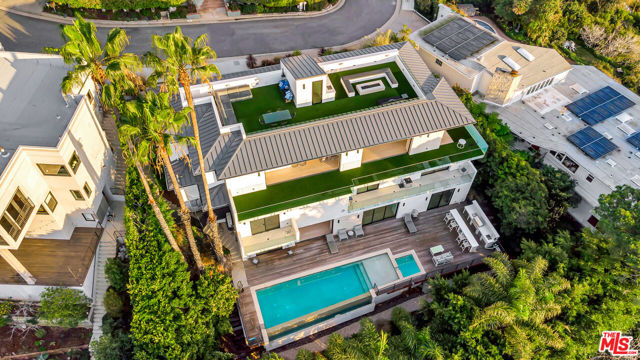 Sited on a quiet residential street just minutes away from the Palisades Village, this modern new construction estate boasts complete privacy, panoramic ocean views, and multiple entertaining spaces. The private elevator will escort you across the tri level contemporary home that features six large en-suite bedrooms and seven and a half bathrooms, plus a bonus room for a home office or gym. A chef's kitchen with Miele appliances, and a walk in pantry occupy the main level, while the lower level features a large movie theater with a unique light up onyx bar, a wine room, and a secondary family room with sliding pocket doors opening seamlessly to the heated infinity edge pool, spa and built in BBQ. Separate his and hers master bathrooms with walk in closets, and a private balcony complete the master bedroom. A large roof deck with stunning views, a second built-in BBQ, two separate seating areas and a fire pit offer a truly special area to watch both the sun rise and set across the ocean. With on site parking for 5 cars, including a 3 car polished floor garage this home checks all the boxes and truly needs to be seen in person to appreciate