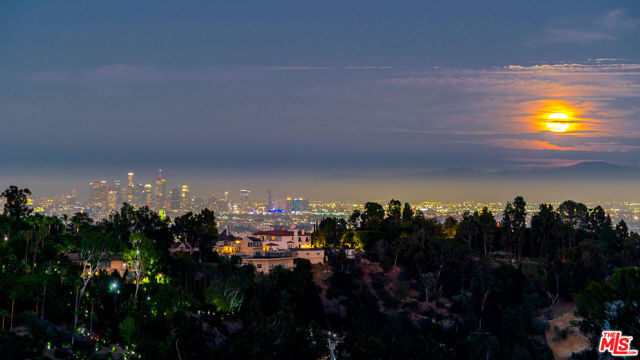 1234 STRADELLA Road Los Angeles, California Sited on a breathtaking view promontory in prime Lower Bel Air, this view estate is sited on two legal lots totaling FIVE ACRES and is one of the best development or expansion opportunities in Los Angeles surrounded by $30M-$150M homes. Existing home is an elegantly appointed Hampton's style home with double height living room, walls of glass showcasing expansive canyon and DTLA/Century City views. Perfect for entertaining with multiple balconies, fire features, and a large pool deck. ROOM TO EXPAND! This is a once in a lifetime opportunity to build a legendary new construction tour-de-force, amongst multi-million dollar estates such as, "The One."