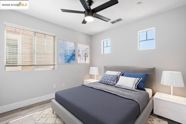Bedroom featuring wood finished floors and ceiling fan