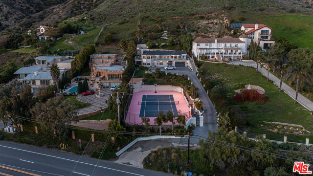 Luxury Live Auction! Bidding to start from $4,000,000! This magnificent home is set high on the hill on an expansive 3.65 acres in Malibu. This recently renovated property has incredible sweeping ocean views overlooking the re-surfaced North-South tennis court. It boasts views from nearly every room. The home is set on a botanic type of garden with a long private driveway and parking for over 10 cars plus you can walk to a privately deeded beach. This elevated home has unobstructed ocean views and will not disappoint you.