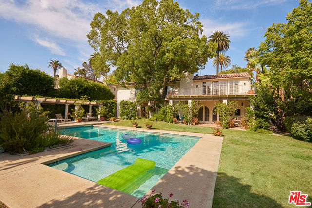623 N Hillcrest Road Beverly Hills, California First time on the market in 55 years comes this majestically situated Grande Dame of a Mediterranean located in the flats of Beverly Hills. These opportunities so rarely come around. Architect Peter Choate added seamless design modifications and elements to this natural beauty. First floor: entry to splendid double living room with two wood-burning fireplaces, crown moldings and coffered ceilings, wet-bar, powder room, cozy library with its rich woods, built-in bookcases and wood-burning fireplace, formal dining room, breakfast room and pantry and great chef's kitchen. Most rooms on the first floor have French doors opening to a wonderful garden and pool area with pool house. Second floor: gallery library, office, two secondary bedrooms with Jack and Jill bathrooms, family room or playroom, housekeeper's room and spacious master bedroom with uniquely beamed ceilings, wood-burning fireplace and dual bathrooms and walk-in closets. There are French doors leading to a balcony overlooking garden and pool area. Other features include: hardwood flooring and pavers, stained glass windows and front and rear staircase. Great grounds, parking, curb appeal and prime Beverly Hills street, combine with interior features to be the perfect ingredients for this delicious home offered to you!