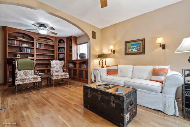 Family room off the living room complete with custom bookshelves to create a library.