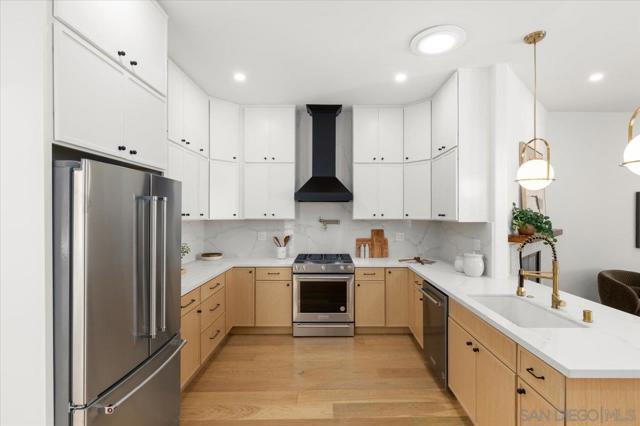 The gourmet kitchen boasts Quartz counters, stainless steel appliances including a french door refrigerator and 6 burner stove, sleek cabinetry, and a spacious pantry with a espresso station, perfect for culinary enthusiasts.