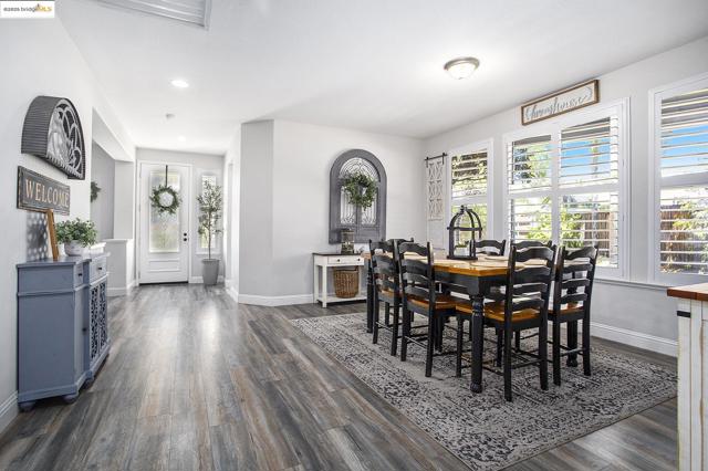 Dining room featuring a healthy amount of natural light, laminate wood-style floors, and recessed lighting