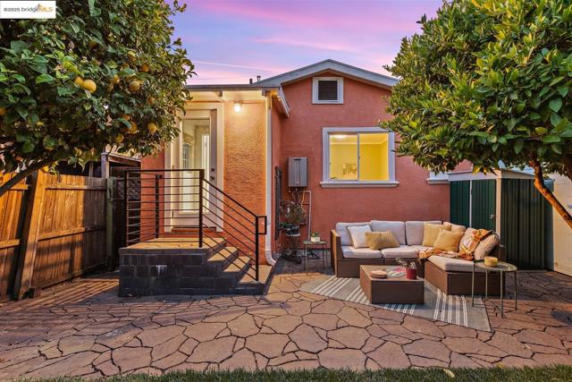 Back of property featuring a patio, stucco siding, and an outdoor hangout area